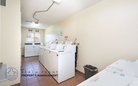 a laundry room with several washes and dryers in it